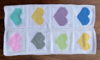 Beautiful hand knitted baby’s blanket, featuring heart motives in various pastel colours Keeps your little one warm and snug Crafted with care, using high quality yarn 100% super soft Acrylic yarn